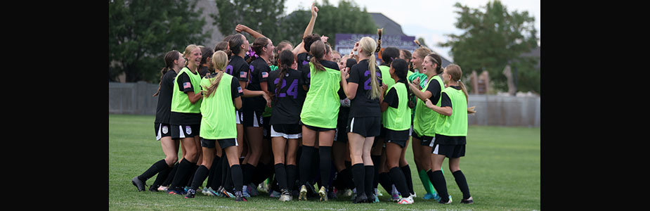 Picture of RHS soccer team cheering in a huddle