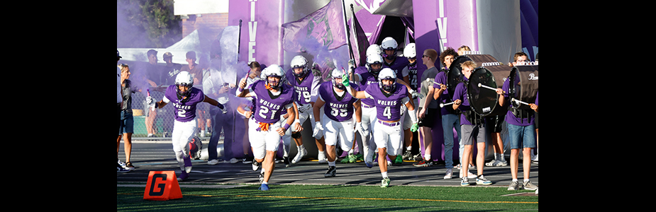 RHS football players running onto the field